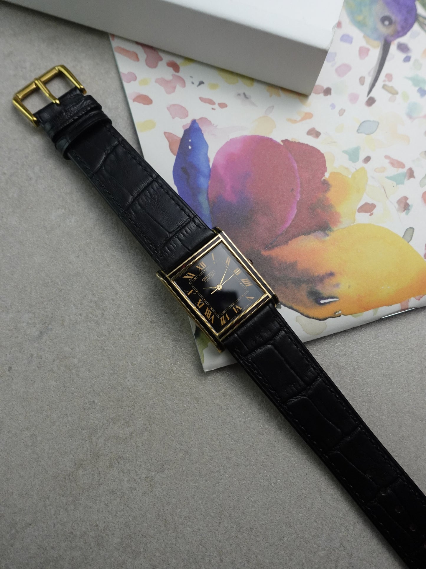 Orient Tank Art Deco case with ruby lacquer inserts on case